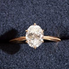 a close up of a ring with a diamond on it