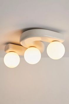 three round lights are hanging from the ceiling