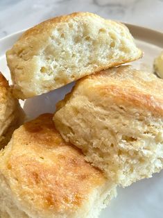 three pieces of biscuit sitting on top of a white plate