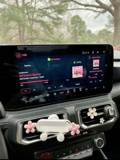 the dashboard of a car with an app on it's screen and some flowers