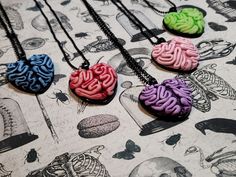 "Brain heart pendants Item made out of clay. Color may be slightly different depending on your screen settings. Make sure to avoid extreme temperatures and direct sunlight to maintain the structural integrity and vibrant colors of your art. Please remember that every piece in my shop is handmade. Color placement may not be exact. Each one made will always be slightly different. Although I do my very best to get everything as perfect as possible, there may be an occasional tiny imperfection, but Brain Necklace, Scene Goth, Tattoo Board, Skater Outfits, Clay Color, Scene Outfits, Brain And Heart, Heart Pendants, Black Sparkle