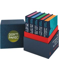 the don't panic books are stacked on top of each other in front of a box