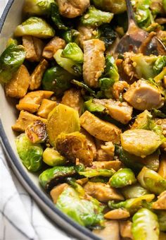 a bowl filled with chicken, brussels sprouts and brussel sprouts