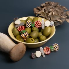 olives are in a bowl next to some other items