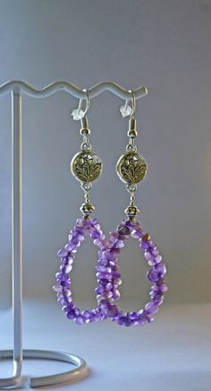 Beaded Amethyst  gemstone  chip earrings Birthstone handcrafted with flower bead nickle free  very purple, with strand of amethyst chips,  birthstone gift item. earings are amethyst chips with little flower beads, all nickle free. each one will be unique since each stone is naturally different and we create the earrings by hand. The little flower bead is approx. 1/2" across, and the chip loop is approx. 1" across, and length from top of earwire to bottom of loop is approx. 3 1/8" Chip Earrings, Power Stone, Birthstone Gifts, Flower Beads, Wedding Jewelry Earrings, Amethyst Gemstone, Wedding Earrings, Beaded Flowers, Gift Item