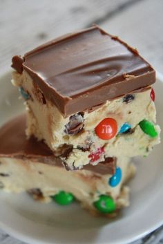 two pieces of cake on a plate with chocolate and m & m candy bars in the middle