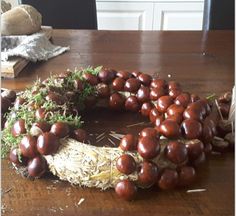 a wreath made out of mushrooms on top of a wooden table