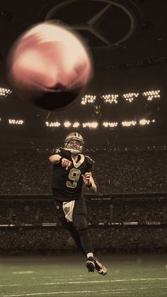 a football player is in mid air with the ball coming towards him, on a stadium field