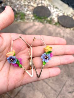 Handcrafted polymer clay earrings.   The length is 5.5 cm and the width is 1 cm (the largest flower).  Please note that the sizes are approximate due to handmade nature of each component, i.e. leaves, petals etc.) The frames are handcrafted from sterling silver wires. Materials: Gold plated non tarnishing hardware and Polymer clay, Why polymer clay earrings?  - Lightweight  - Doesn't tarnish  - non allergic   - unique Kindly note that colours might slightly vary based on the type of device used. Handmade Flower Earrings In Polymer Clay, Gold Flower-shaped Polymer Clay Earrings, Artistic Multicolor Flower Earrings, Unique Flower-shaped Polymer Clay Earrings, Playful Flower-shaped Spring Earrings, Yellow Flower-shaped Earrings With 3d Flowers, Multicolor Flower-shaped Artsy Earrings, Large Flowers, Floral Bouquets