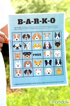 a person holding up a poster with dogs on it's face and the words bark - k - o