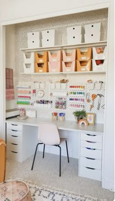 a white desk with lots of crafting supplies on top of it and storage bins