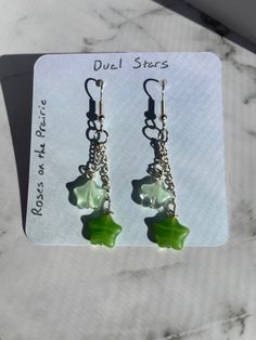 These Earrings feature two glass star beads. One star hangs slightly above the other, so they overlap slightly. They are not heavy and are comfortable to wear. Green Star Earrings For Pierced Ears, Star Earrings Dangle, Green Jelly, Stars Earrings, Galaxy Earrings, Star Beads, Earrings Star, Glass Stars, Earrings Green