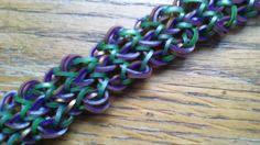 a purple and green chain on a wooden table