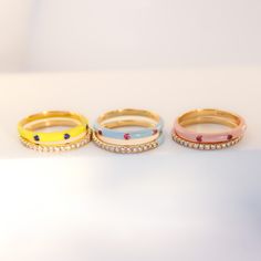 This is a great ring to wear on its own but works even better in a stack. You can really make a whole rainbow of colors on your finger with just a couple of rings! Let’s play! Precious Metal: 18K Solid Yellow Stones: Pink Sapphire with Baby Blue Enamel, Ruby with Peach Enamel or Blue Sapphire with Neon Yellow Enamel .05ct each design Enamel Colors: Baby Blue, Peach or Neon Yellow Sizes: 7 Width: 2.4mm Other rings shown on the pictures are sold separately. Wear with care and avoid harsh chemicals Dad Jewelry, Mini Necklace, Gold Diamond Jewelry, Shine Bright Like A Diamond, Blue Peach, Yellow Stone, Enamel Ring, Custom Earrings, August Birth Stone