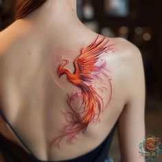 the back of a woman's shoulder with a bird tattoo on it