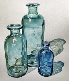 three blue glass bottles sitting next to each other