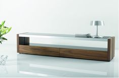 a modern wooden and glass coffee table with a lamp on top