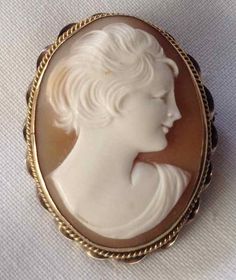 "Cameos can be made from various materials: shell, stone, coral, lava, plastic, glass, or ivory. During the Victorian era, many cameos were made from shell. Jet was not used until the 19th century and in modern times plastic was used and looks very similar to shell. A shell cameo has a curved back and, if it is a carnelian shell, the cameo is older whereas if emperor helmet, the brown and white cameo is modern. Older cameos were not set in gold, but instead in brass, pinchbeck (metal alloy of co Fun Photos, Curved Back, Cameo Brooch, Modern Times, Plastic Glass, Shopping Sites, Gems Jewelry, Victorian Era, Necklace Pendant