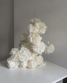 a bunch of white flowers sitting on top of a table