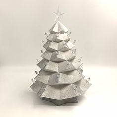 a white christmas tree made out of silver paper