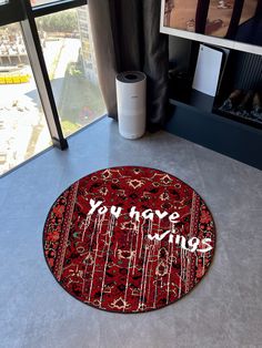 a red rug with the words you have wine on it in front of a window