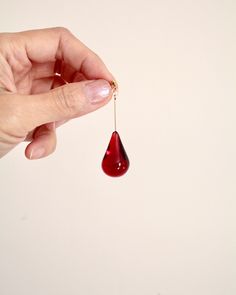 Handmade red teardrop resin earrings with 14k gold filled posts. The red resin teardrop bead is sleek and chic, and the 14k gold filled posts add a touch of luxury. These earrings are perfect for dressing up an outfit or adding a touch of sophistication to a casual look. Actual product color may vary slightly from the images shown. ✦  Material 14k gold filled, brass, lead free, nickel free, resin  ✦  Care instruction Resin is a soft material, sharp and abrasive items can cause scratches to the surface. Moisture is the main factor that speeds up the tarnishing process. Avoid harsh chemicals including chlorine or salt-water as they can cause damage. To clean, use a soft cloth to gently wipe away any dust or residue. We recommend storing your resin pieces on a soft surface in low humidity and Sparkly Accessories, Teardrop Beads, Earrings Red, Holiday Jewelry, Resin Earrings, Geometric Earrings, Gold Filled Jewelry, Polymer Clay Earrings, Statement Jewelry