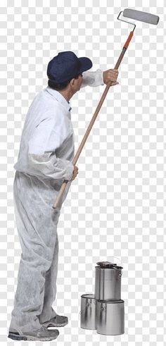 a man in white overalls holding a paint roller and cleaning the floor with a broom