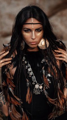 a woman with long hair and feathers on her head