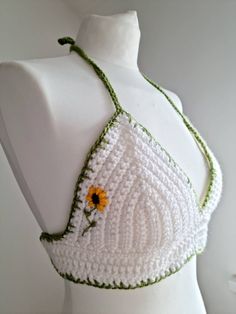 a white crocheted bra with a yellow flower on it