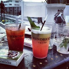 three drinks sitting on top of a table next to books