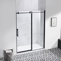 a white and black tiled bathroom with a walk in shower