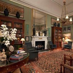 a living room filled with furniture and a fire place in the middle of a room