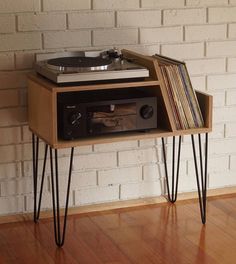 an old record player is sitting on top of some hairpin legs