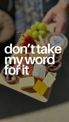 a person holding a tray with cheese and crackers on it that says, don't take my word for it