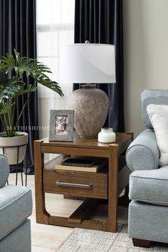 a living room scene with focus on the end table and chair next to the couch