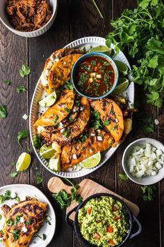 grilled chicken with salsa and guacamole on a plate next to other dishes