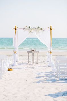 an outdoor wedding set up on the beach