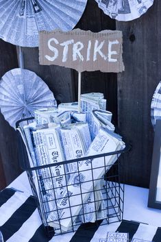 a basket filled with money sitting on top of a table next to an umbrella sign