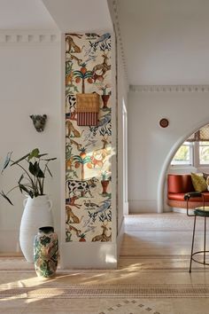 a living room filled with furniture and walls covered in wallpaper