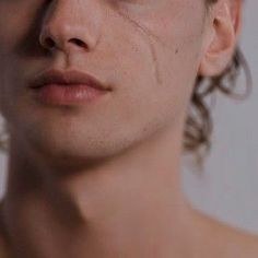 a close up of a man's face with wrinkles on his eyes and nose