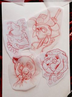 some red ink drawings on white paper