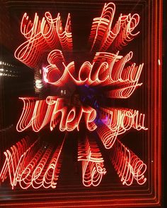 a neon sign that says, you're exactly where you need to be in the city