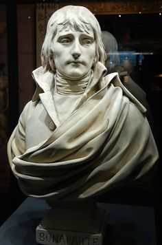 a statue of a man with white hair and wearing a scarf on top of it's head