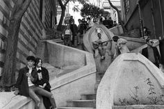 black and white photograph of people sitting on stairs