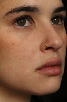 a close up of a person wearing earrings