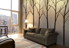 a living room filled with furniture and tall windows