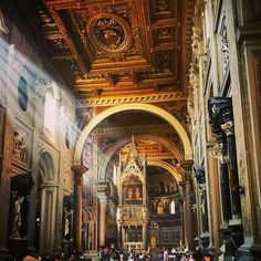 the inside of a church with people walking around