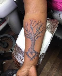 a person with a tree tattoo on their arm