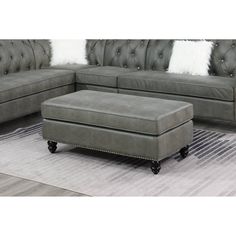 a gray couch and ottoman in a living room