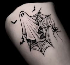 a black and white photo of a spider web tattoo